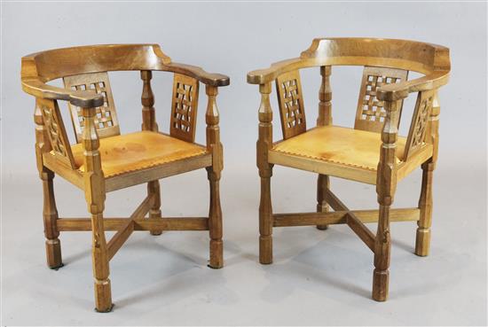 Robert Mouseman Thompson. A pair of oak monks armchairs, W.2ft 1in. D.2ft 11in. H.2ft 8in.